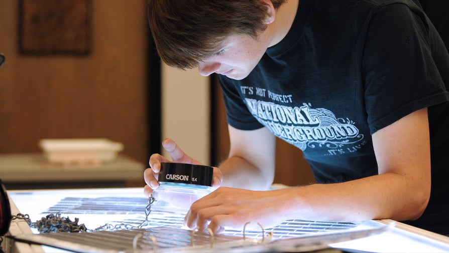 student inspecting film