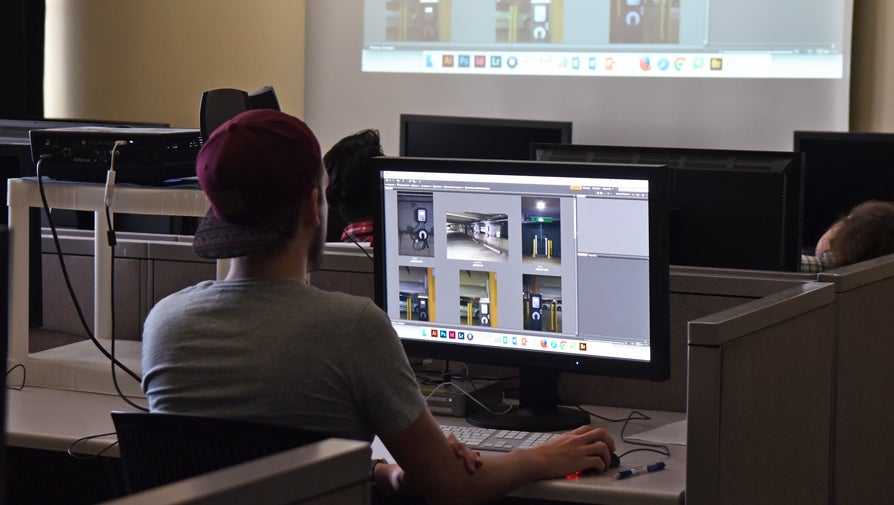 student editing photos on desktop